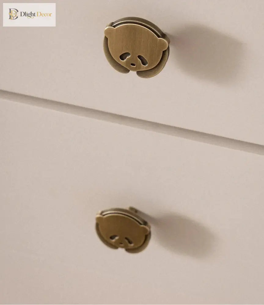 Brushed brass panda cabinet knobs on light cabinet drawers, single-hole round mount