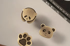 Brushed brass panda cabinet knobs: panda face and paw print shapes, single-hole style