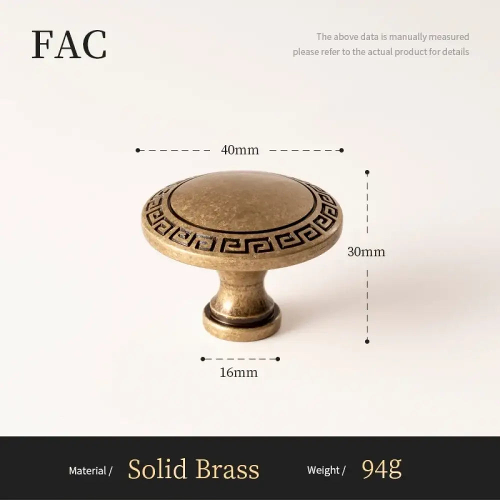 Antique brass cabinet knob with round top and Greek key border pedestal