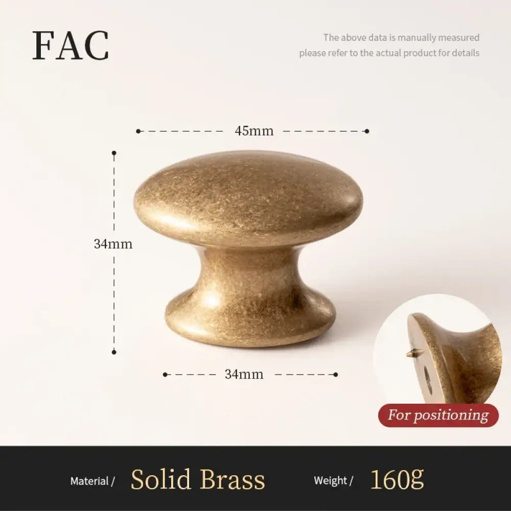 Antique brass cabinet knob with domed mushroom-style top and pedestal base
