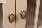 Antique brass cabinet knobs with oval tops on light cabinet doors