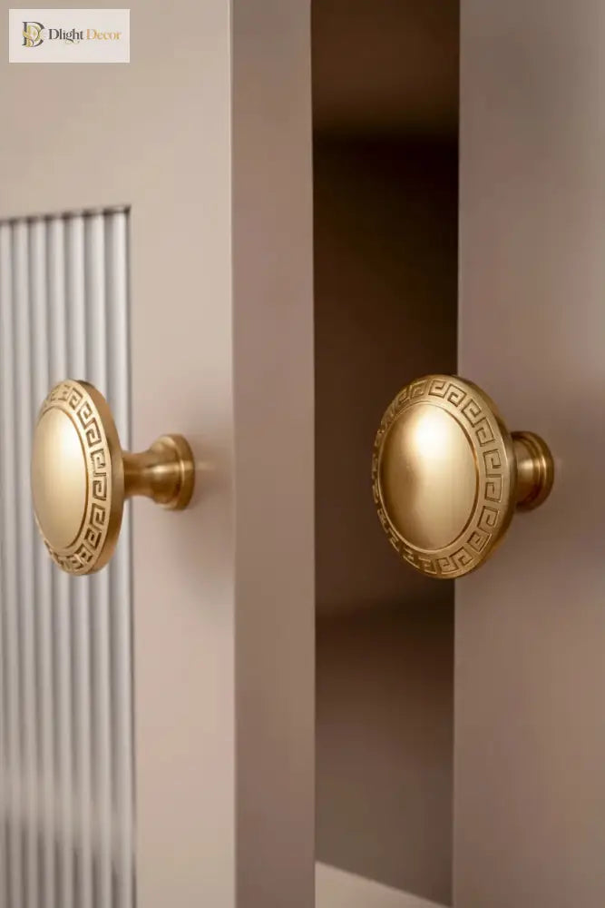 Antique brass cabinet knobs with round Greek key medallion backplates