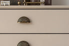 Brushed brass half-moon drawer pull with ribbed shell design