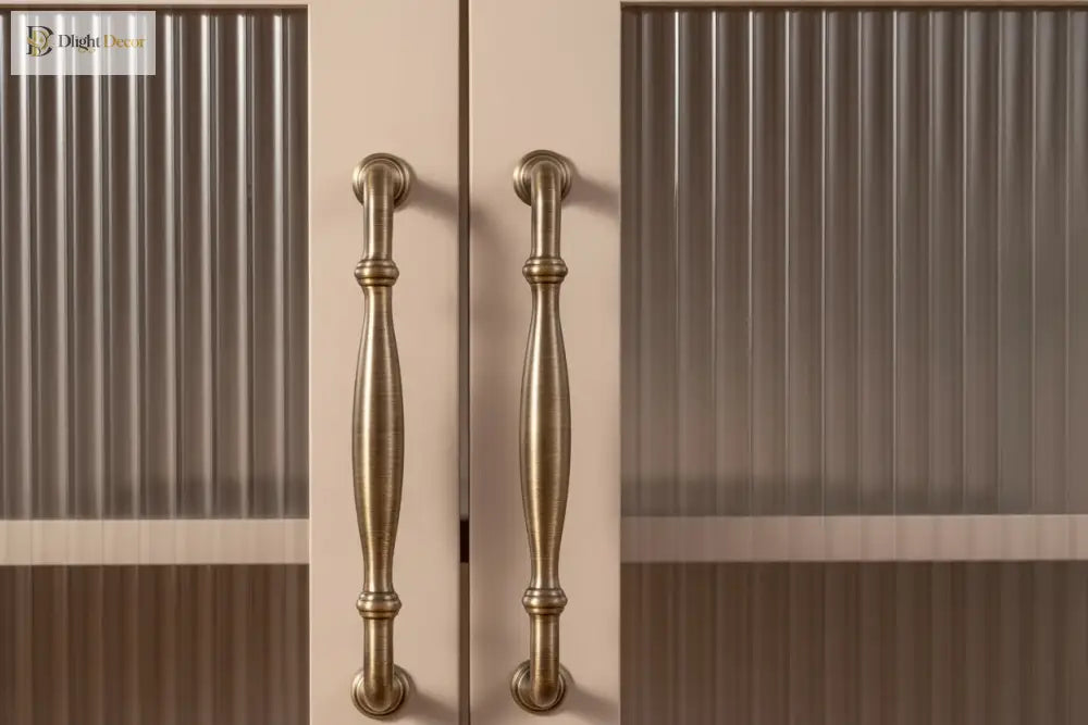 Antique brass T-bar cabinet pulls mounted on cabinet doors