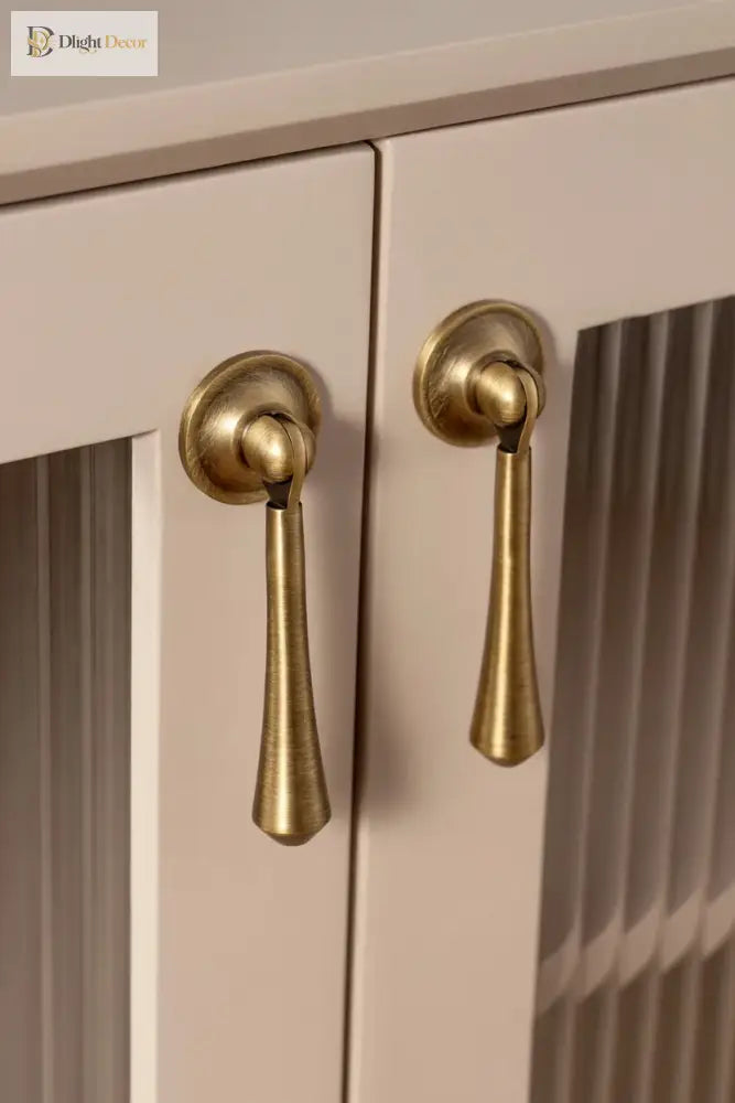 Antique brass T-bar pulls and round knobs on light cabinet doors