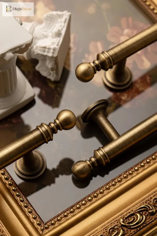 Brushed brass T-bar cabinet pull detail with round knobs and matching curved wall mounts