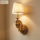 Decorative copper wall sconce with horse head ornament and beige fabric drum shade