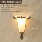 Retro gold wall sconce with glowing frosted glass shade and ornate centerpiece