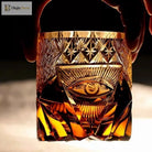 Amber-gold crystal tumbler with hand-engraved eye motif and vertical facet panels