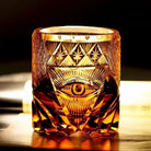 Amber-gold crystal old fashioned tumbler with hand-engraved eye motif and faceted cutwork