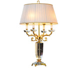 Fabric LED table lamp with pleated cream shade and ornate gold base with clear crystal accents