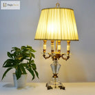 Modern fabric LED desk lamp with warm yellow pleated shade and gold-tone base