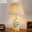 Floral ceramic lamp with gold base and pleated fabric shade for bedside tables.