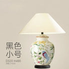Ceramic table lamp with white shade and blue bird motif on a smaller vase base