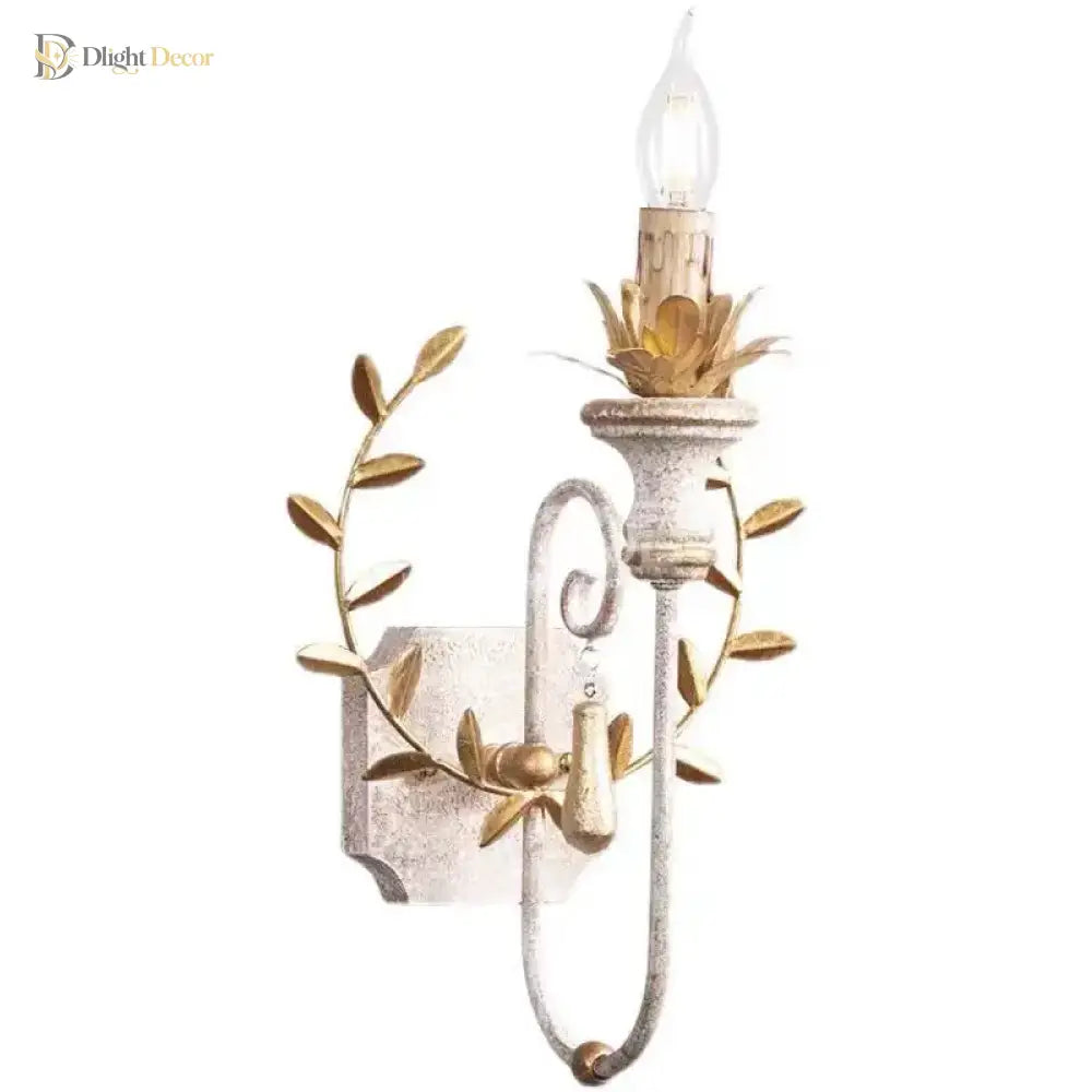 Iron candle sconce with clear LED bulb, gold leaf ring, and textured back plate