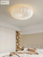 Cream fabric dome ceiling light with ribbed texture in a modern bedroom