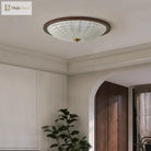 Walnut round flush-mount ceiling light with clear ribbed acrylic diffuser on white ceiling