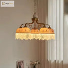 Gold three-head pendant light with white ceramic shades, brown floral trim, tassel fringe on chain