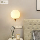 Modern Elegance Meets Warmth: Gold Sphere Bedside Wall Sconce