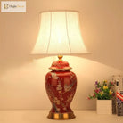 Ceramic LED desk lamp with cream shade and red ceramic body with gold floral and bird motif
