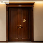 Gold ring door knocker on dark wooden front door