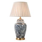Indigo patterned ceramic lamp with beige pleated drum shade and gold base detailing