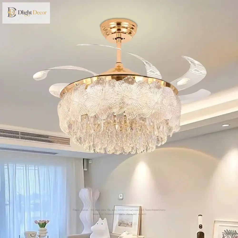 Gold crystal ceiling fan light with clear blades and glowing chandelier-style glass