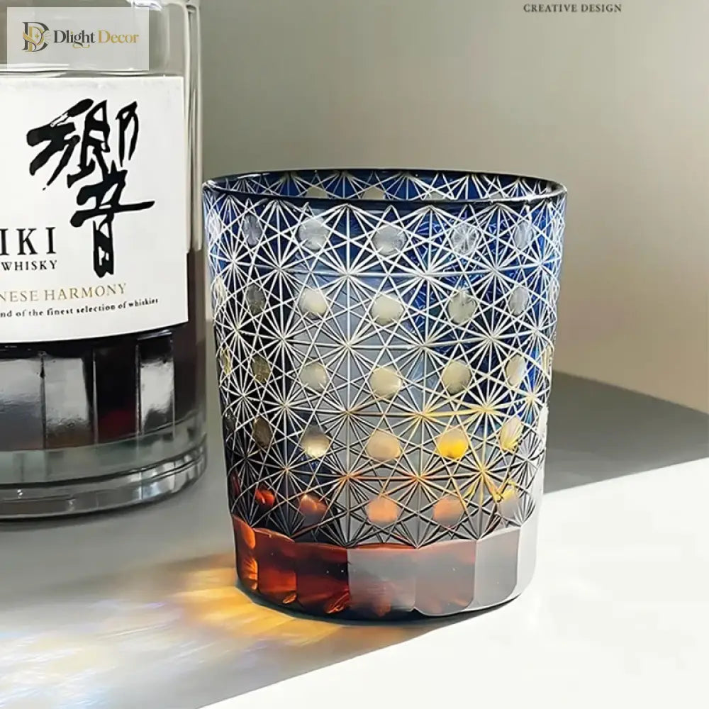 Blue cut crystal whisky glass with white geometric star pattern