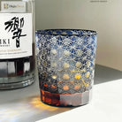 Blue cut crystal whisky glass with white geometric star pattern