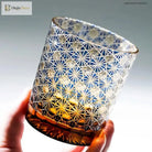 Blue cut crystal whisky glass with faceted geometric pattern and amber band