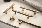 Antique brass cabinet pull with knurled grid grip and round end posts.