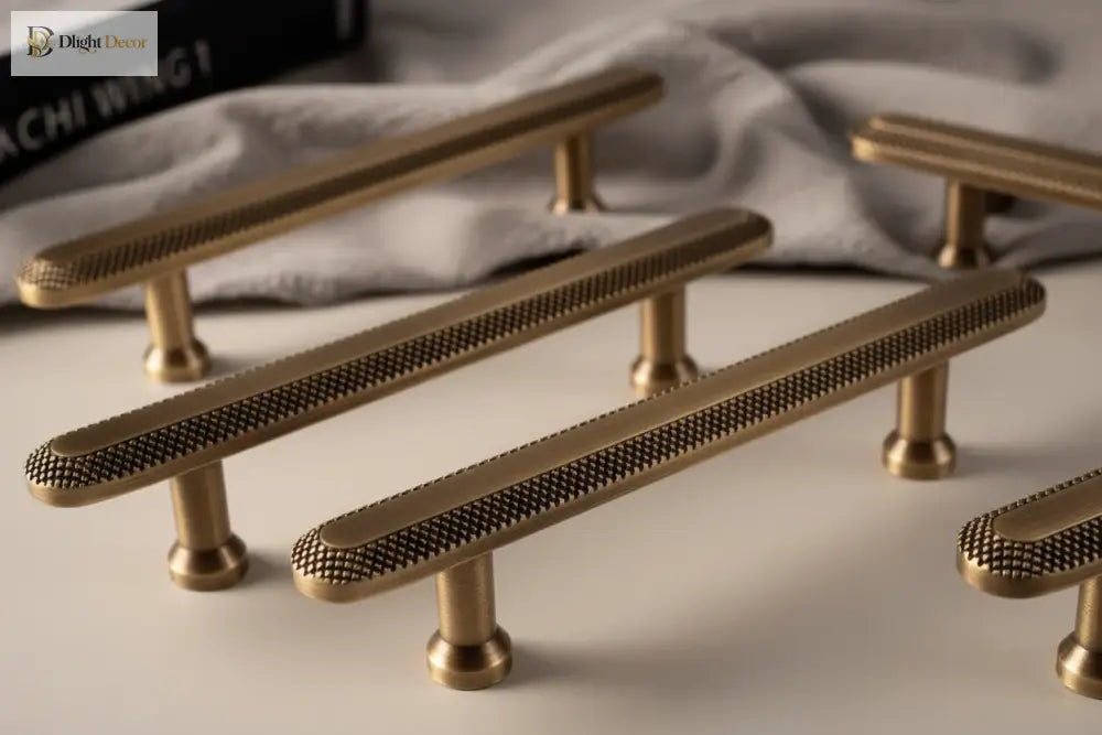 Knurled grid bar cabinet pulls in antique brass, shown with end posts detail.