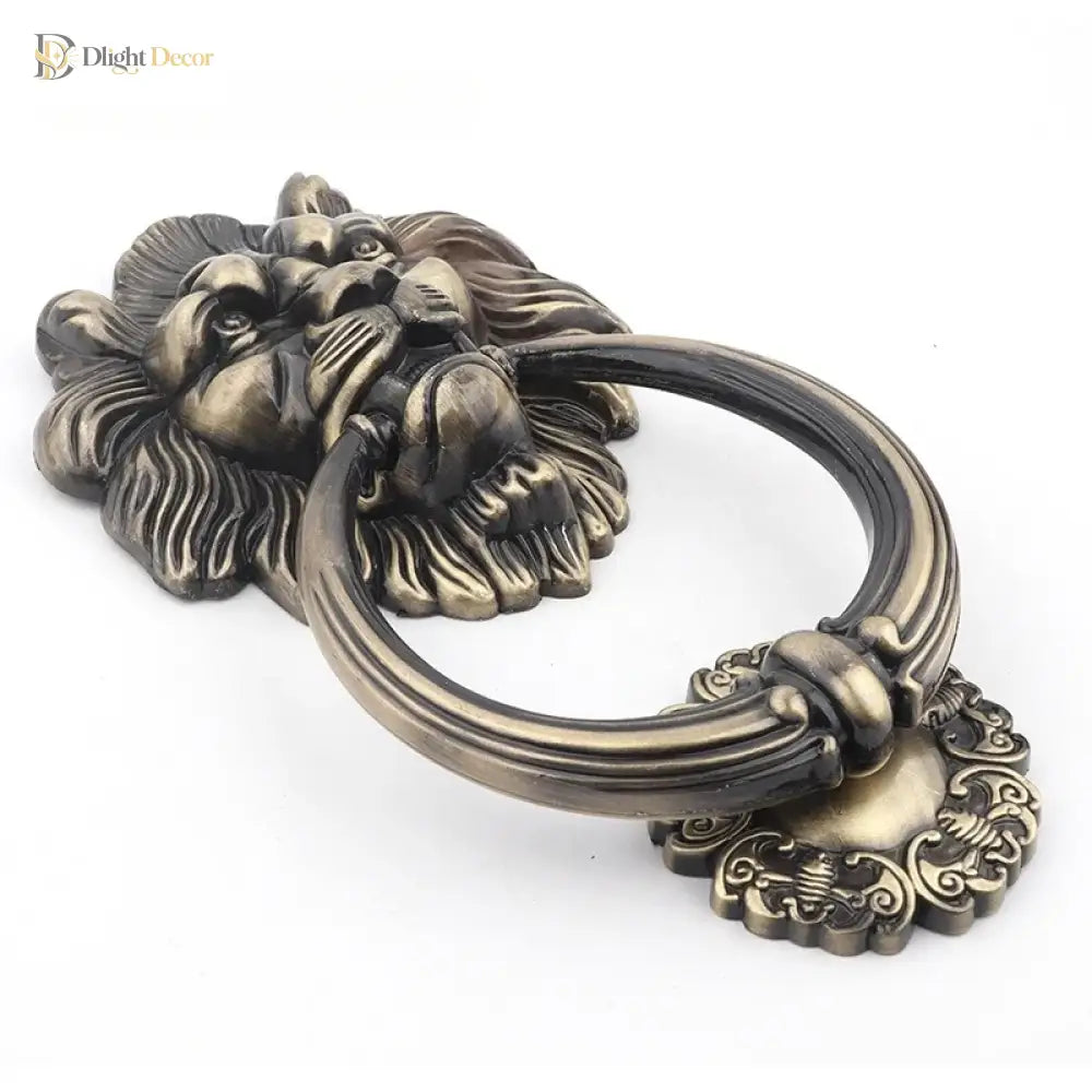 Bronze lion head door knocker with curved ring and filigree ornament, antique finish