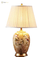 Ceramic LED table lamp with pleated fabric shade, floral artwork, and gold base