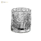 Hammered crystal whiskey rocks glass, cylindrical with textured icy-silver look.