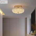 Gold flush-mount ceiling light with clear crystal-style acrylic drum shade