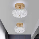Gold flush-mount ceiling light with clear crystal-style acrylic drum shade