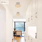 Chrome flush-mount ceiling light with clear crystal-style acrylic drum shade