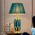 Ceramic LED desk lamp with teal honeycomb base and green pleated shade