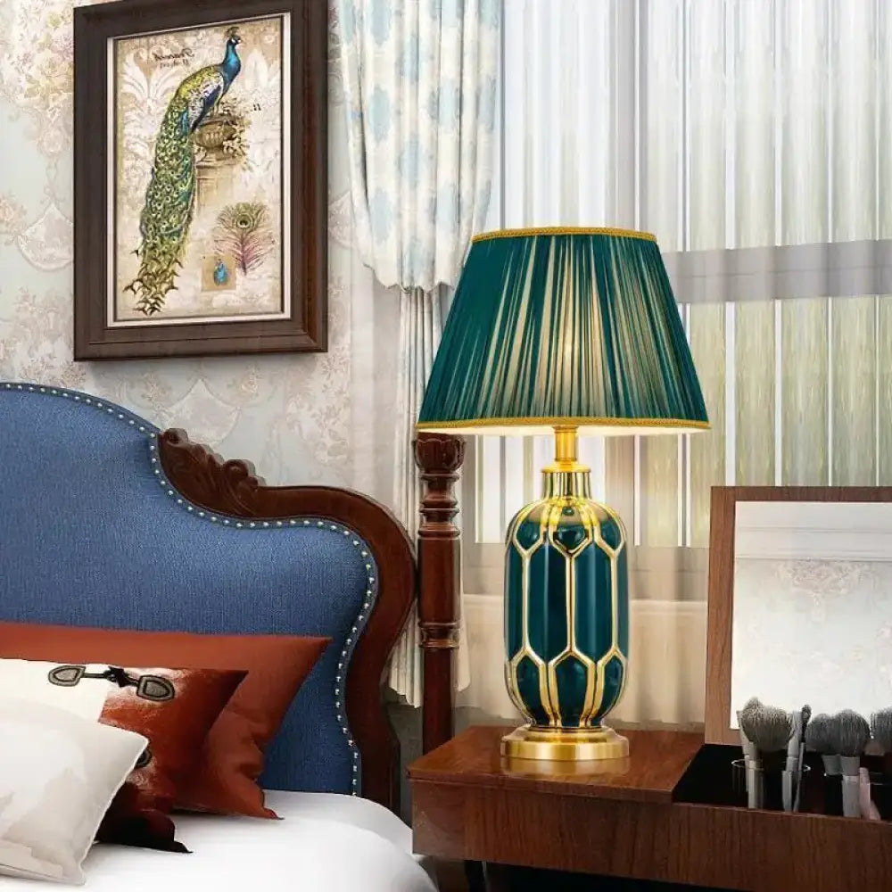 Ceramic LED desk lamp with teal honeycomb base and green pleated shade
