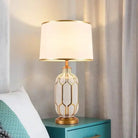 Ceramic LED desk lamp with white shade and clear gold honeycomb base