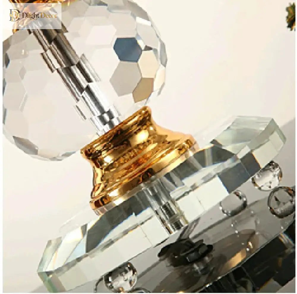 Close-up of gold crystal desk lamp base and clear faceted crystal centerpiece