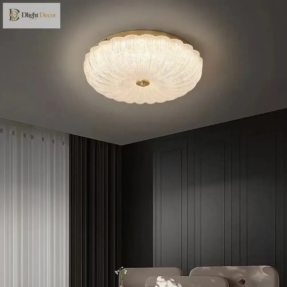 Small round crystal-style acrylic LED flush-mount ceiling light with brass center
