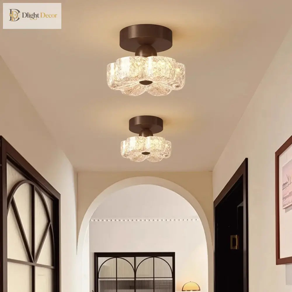 Brown flush-mount LED ceiling light with frosted glass shades on a ceiling