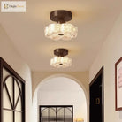 Brown flush-mount LED ceiling light with frosted glass shades on a ceiling