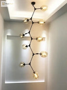Black molecular glass chandelier with clear glass globe lights, ceiling-mounted