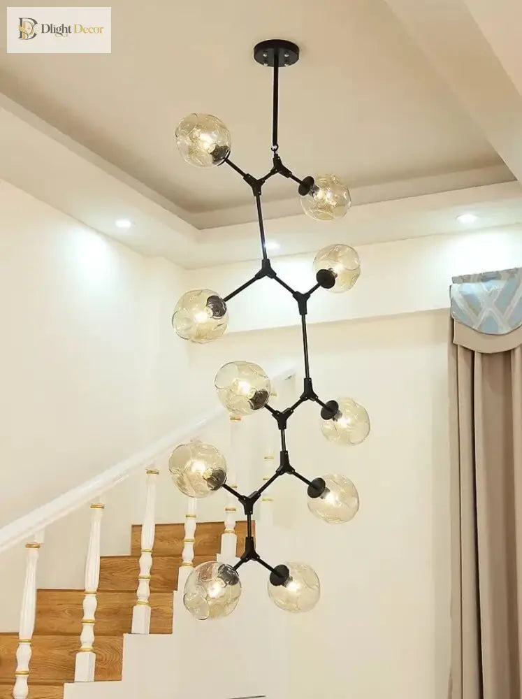 Black molecular glass chandelier with clear globe lights in a stairwell setting