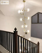 Gold molecular glass chandelier featuring clear globe light heads on a ceiling plate