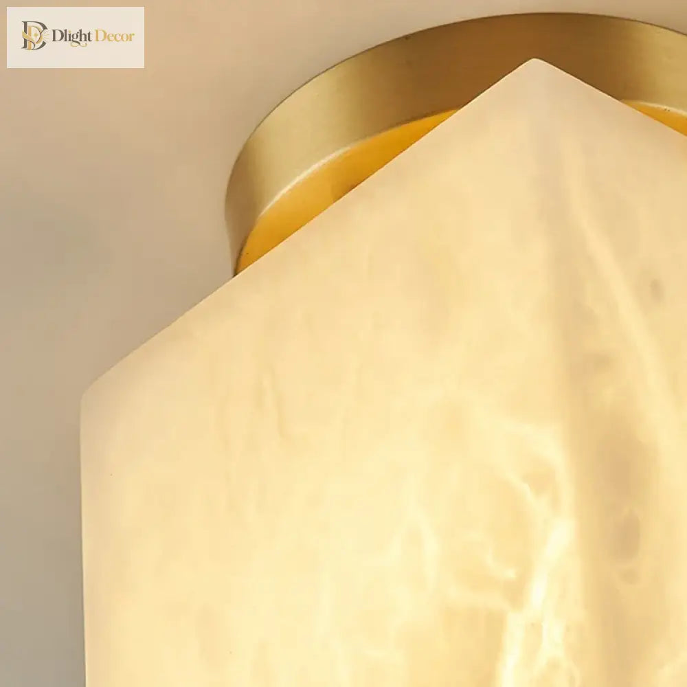 Close-up of gold copper art deco LED ceiling light with marble-pattern shade