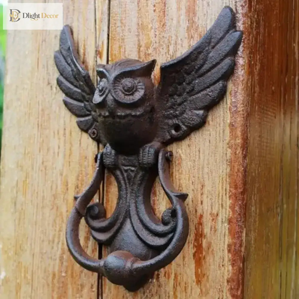 Cast iron owl door knocker, centered view with outstretched wings and arched mounting